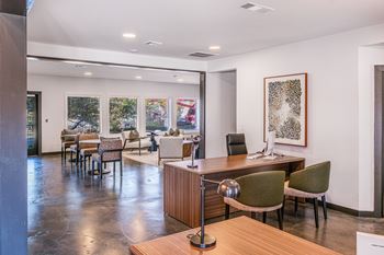 A conference room with a long table and chairs.